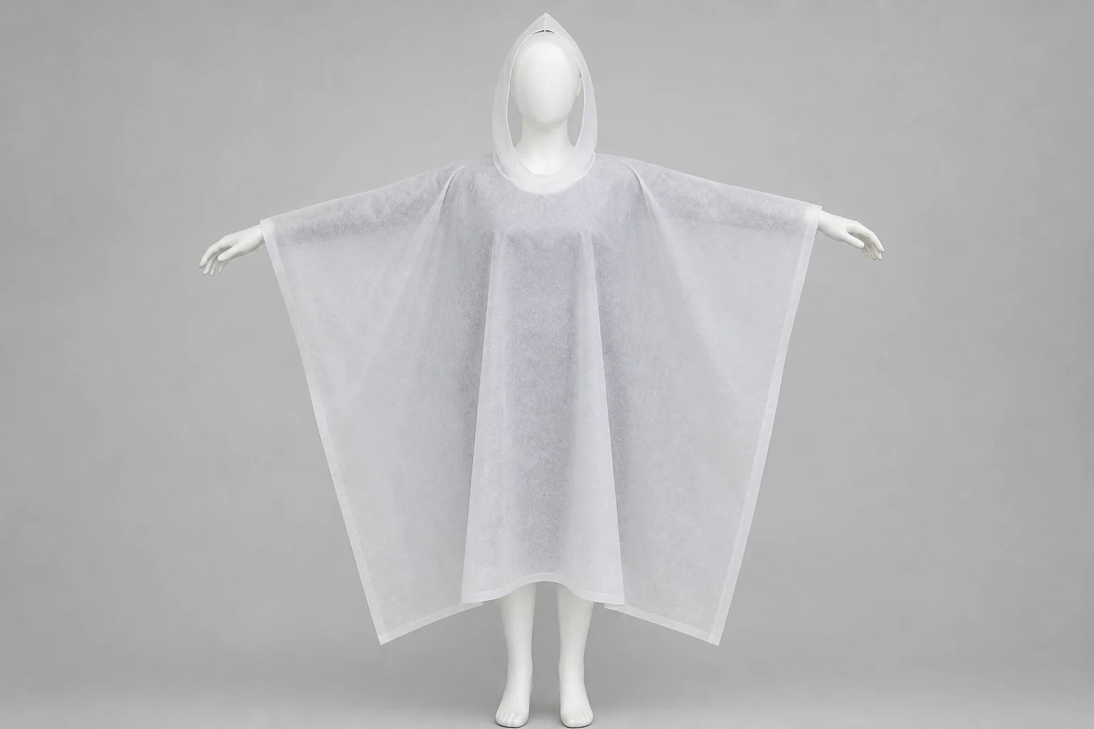 Complete matte fibrous nonwoven poncho shown on a neutral mannequin for garment-geometry review