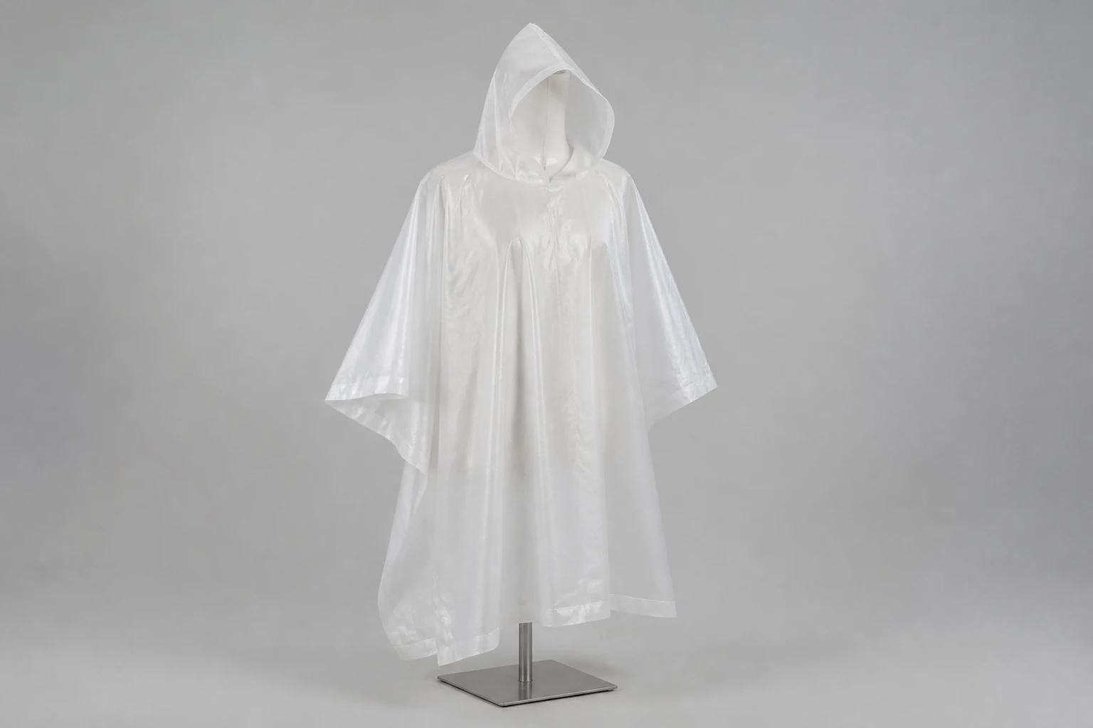 Complete translucent white nonwoven rain poncho on a neutral mannequin