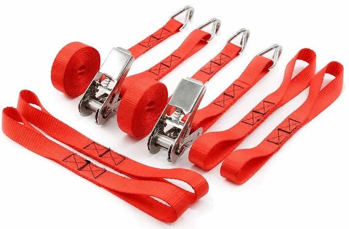 Multiple red ratchet assemblies compare ratchet bodies, hooks, sewn ends and adjustable webbing lengths.