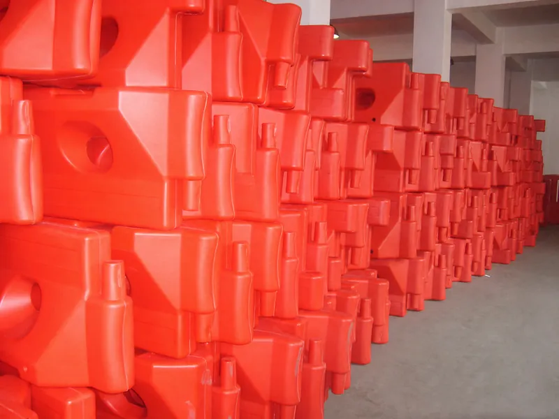 Complete nested orange water-fillable roadway barrier modules showing molded connectors and fill openings