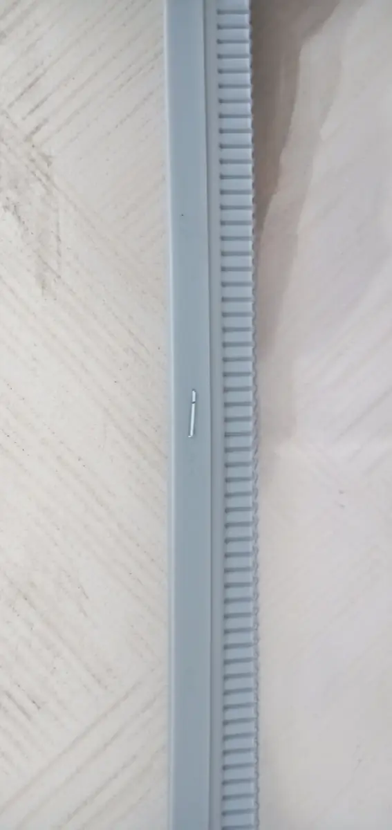 Close view of clear flexible material and a ribbed magnetic-edge carrier profile.