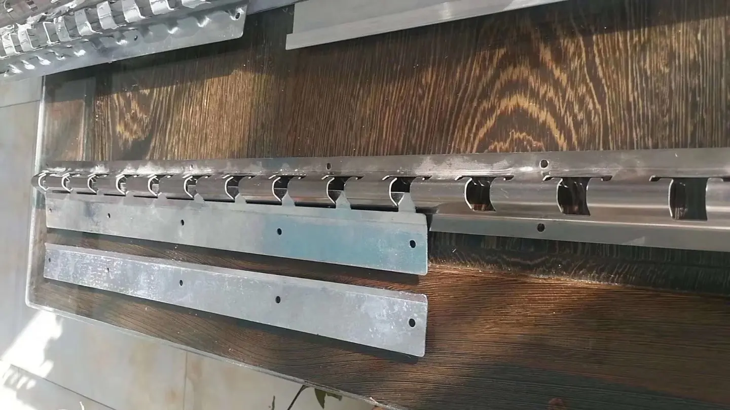 Distinct metal rail and hanger components arranged on a wood-grain review surface.