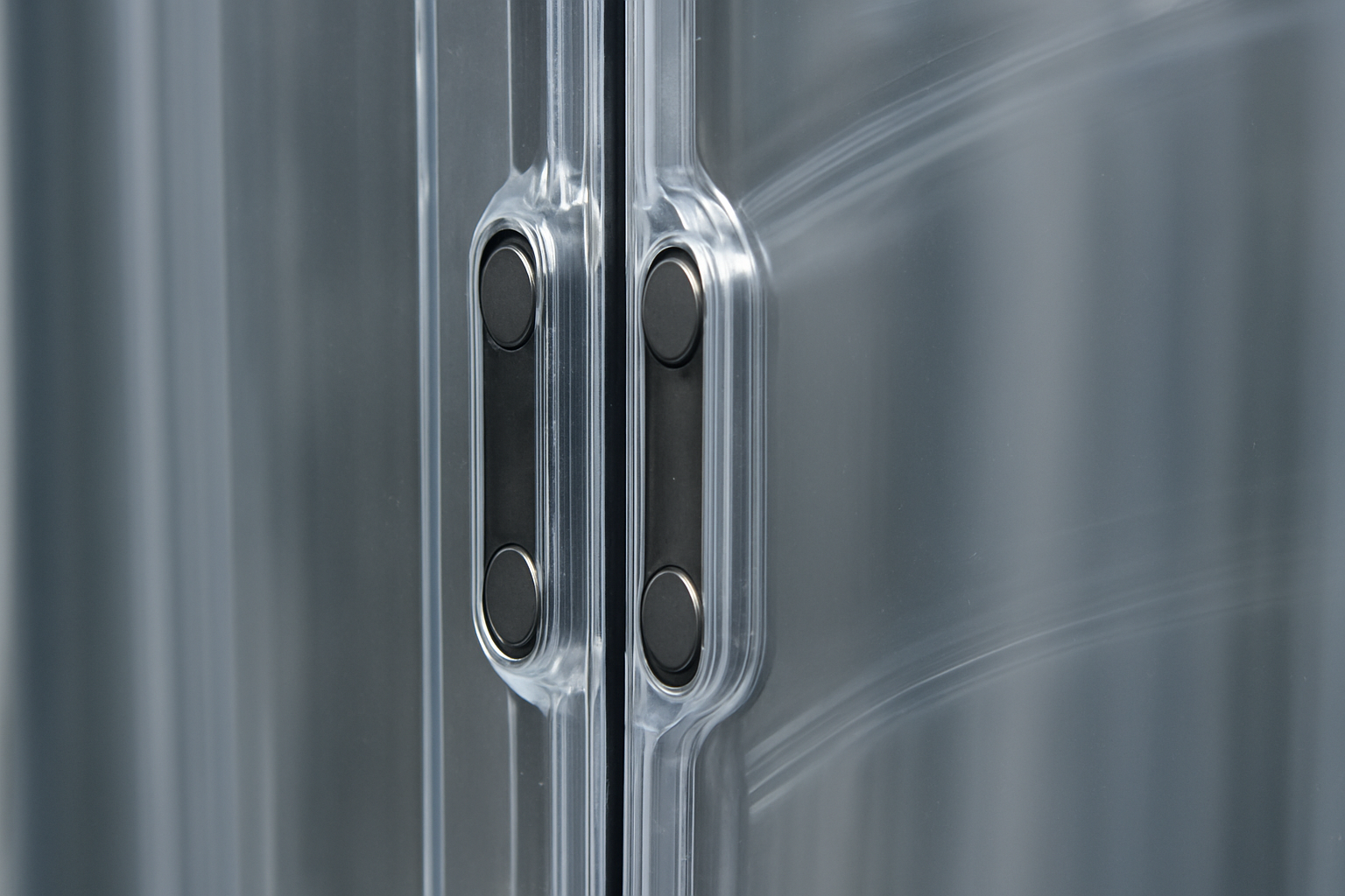 A close-up view of the magnetic seal on a clear PVC strip curtain, showing a tight closure.