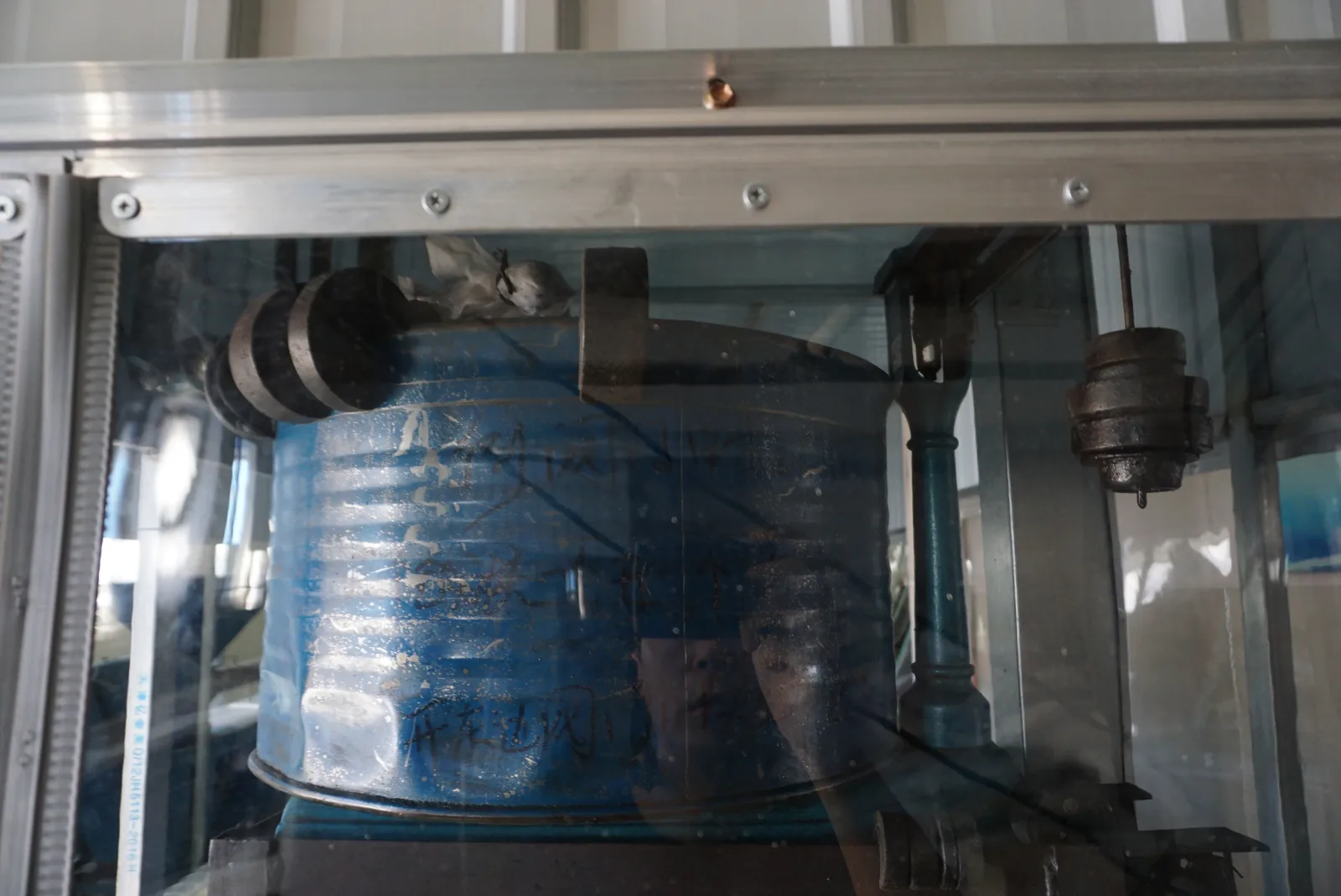 Installed clear panel and upper rail viewed against equipment inside the enclosure.