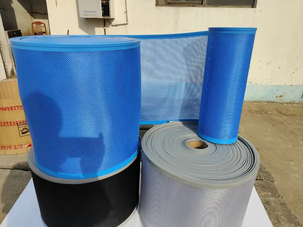 Blue and gray flexible curtain rolls displayed upright and coiled in several visible sizes and surface finishes.